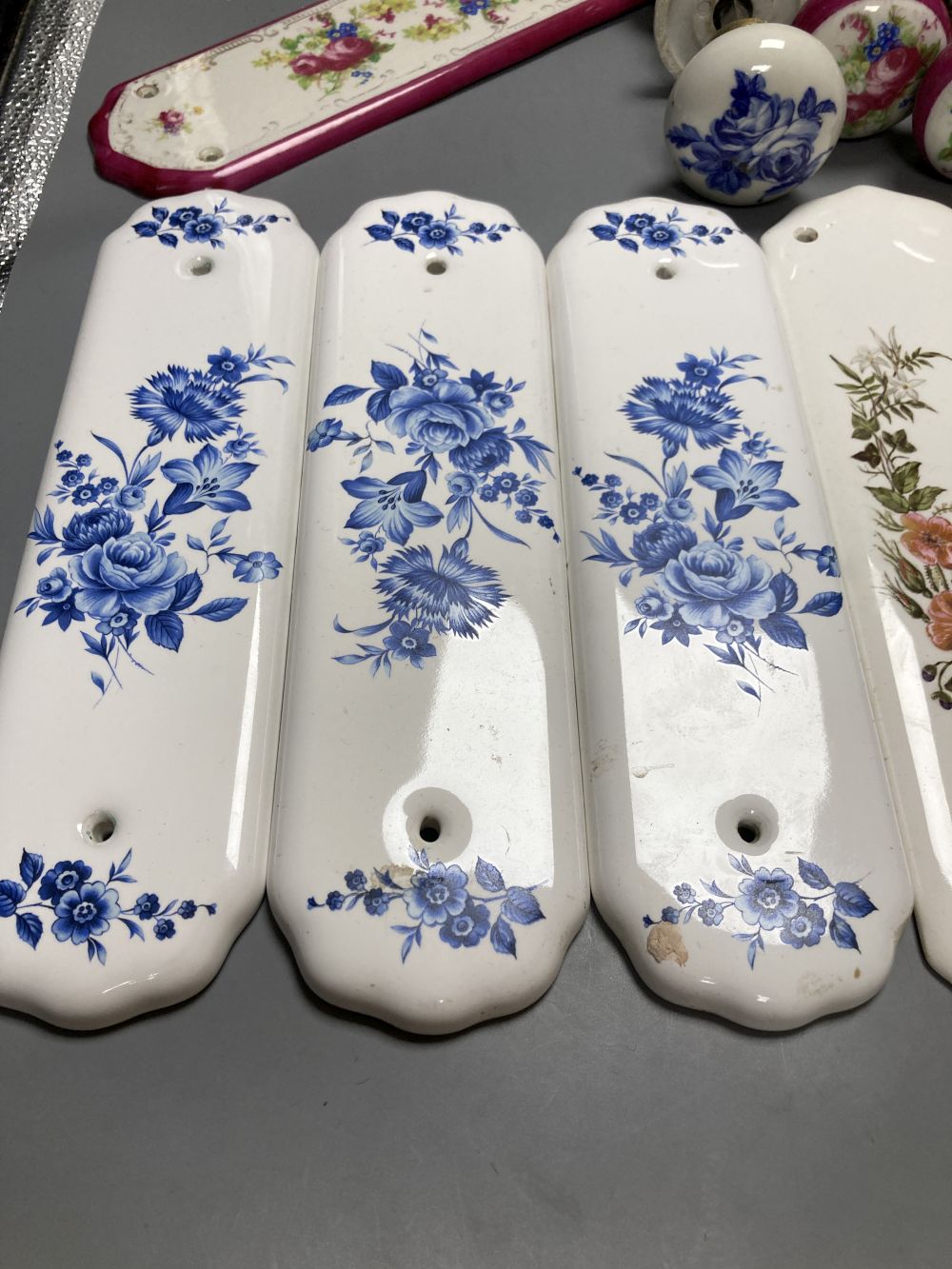 Five pairs of French porcelain door handles and ten porcelain door plates